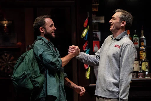 Jerreme Rodriguez and Tony Bingham clasp hands in a scene from Sweat